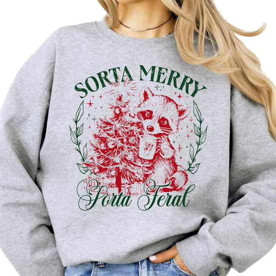 Front view of Sorta Merry Sorta Feral holiday sweatshirt featuring a festive raccoon graphic