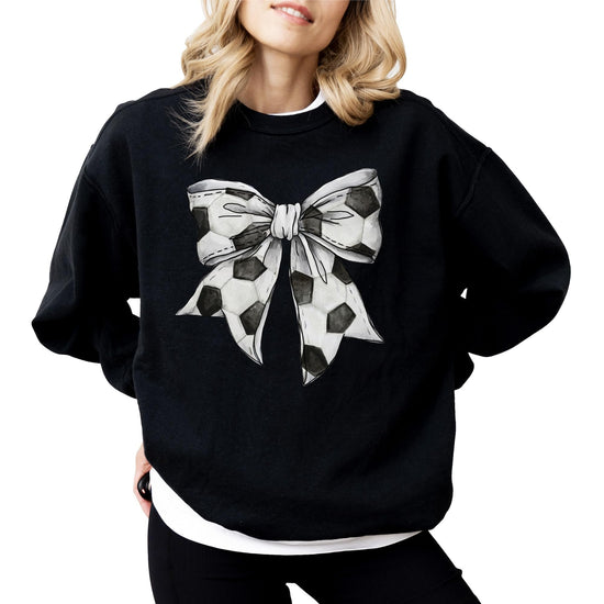 Woman wearing gray soccer coquette bow sweatshirt showing fit and style