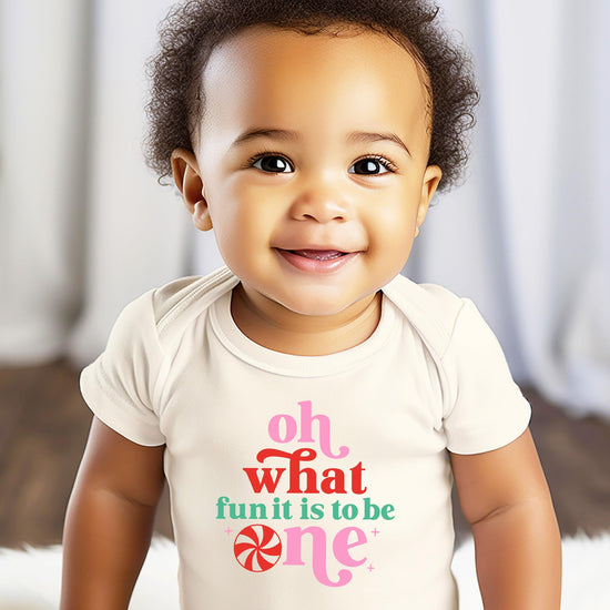 Close-up of Oh What Fun It Is To Be One graphic print on white baby bodysuit