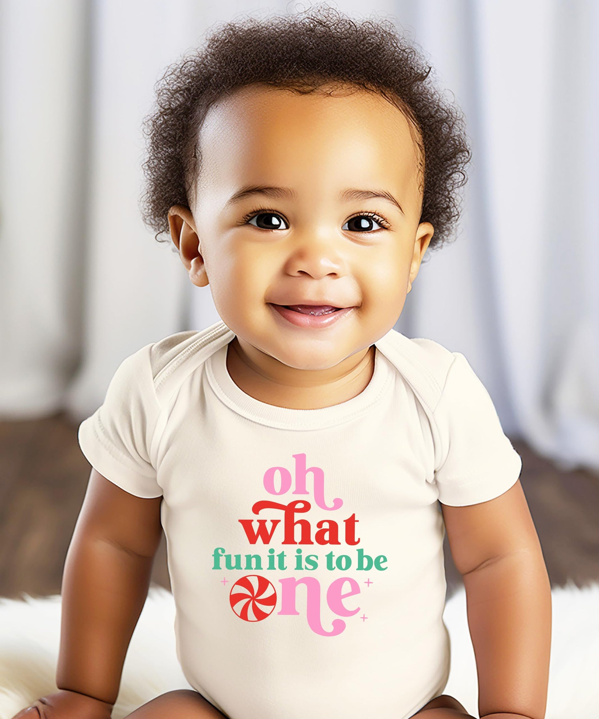 Close-up of Oh What Fun It Is To Be One graphic print on white baby bodysuit