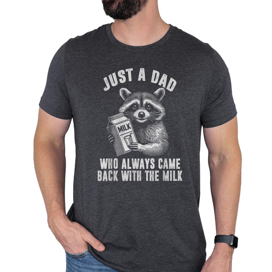 Dark gray heather men's t-shirt with raccoon graphic and text 'Just a Dad Who Always Came Back with the Milk'