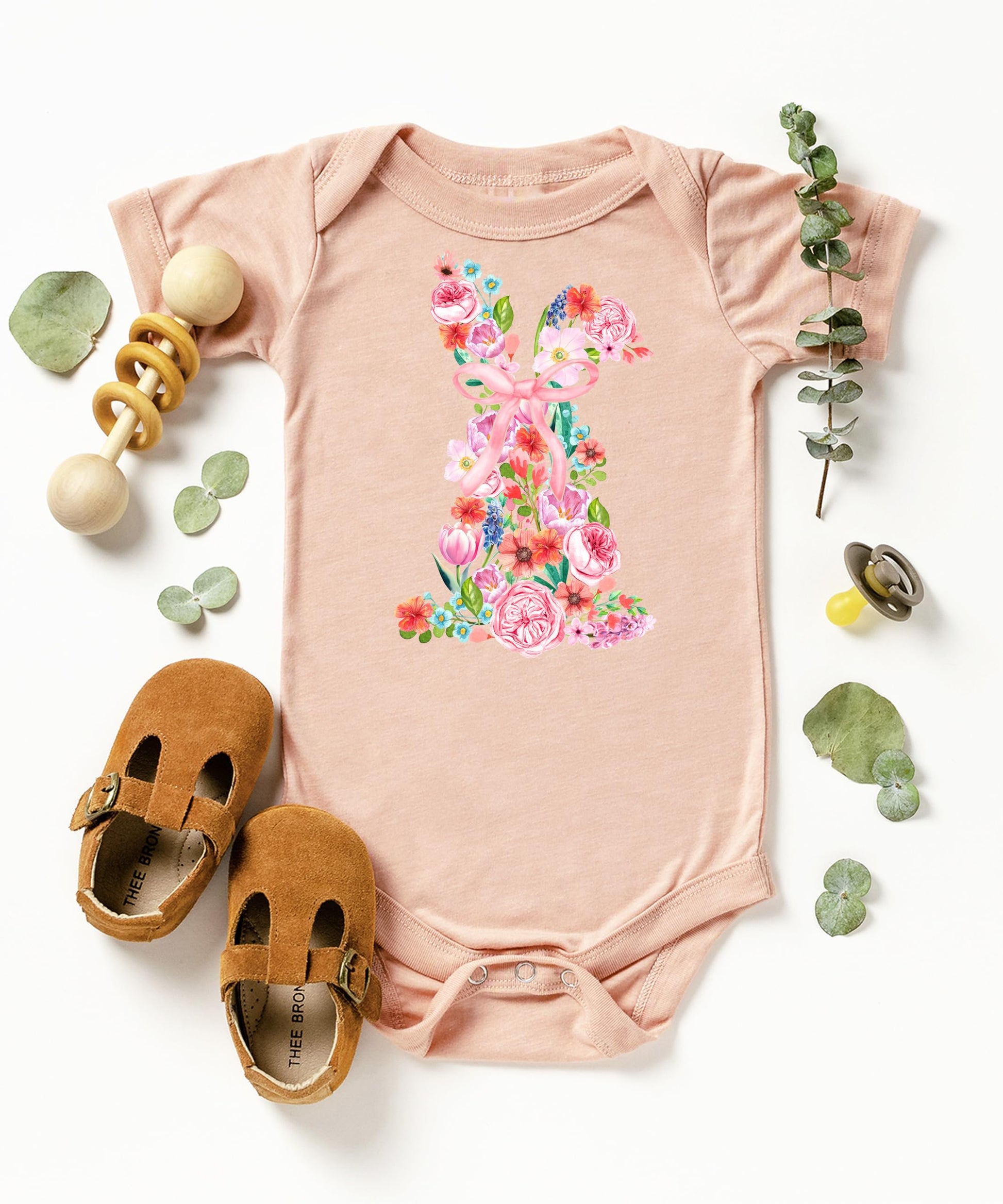 Detail shot of professional print quality on floral bunny Easter bodysuit for infants