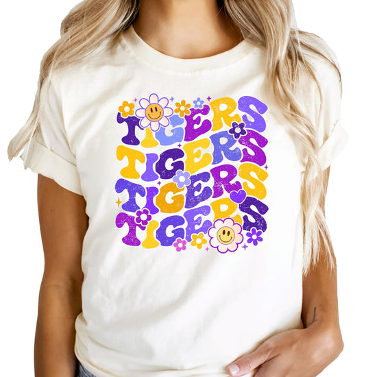 Close-up of Purple Tigers graphic design showing purple retro lettering with decorative flowers