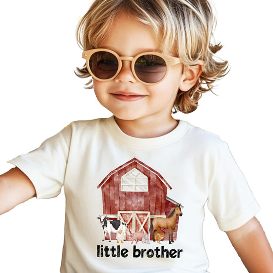 Little Brother sibling reveal bodysuit in natural color with barn and animal graphic