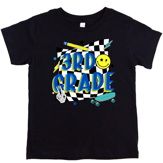 Flat lay of retro 3rd grade boys t-shirt showing colorful skateboard design detail