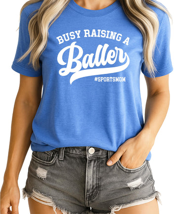 Busy Raising a Baller funny sports mom graphic t-shirt in black