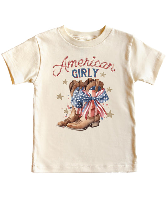Close-up of American Girl western graphic on peach toddler tee showing patriotic cowgirl boots with USA bow
