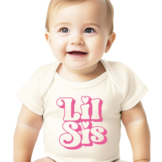 Natural snap bodysuit with retro pink 'Lil Sis' lettering for newborn baby girls