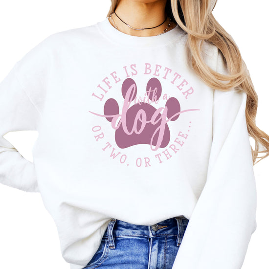 Women's white crewneck sweatshirt with 'Life is Better with a Dog or Two or Three' graphic print