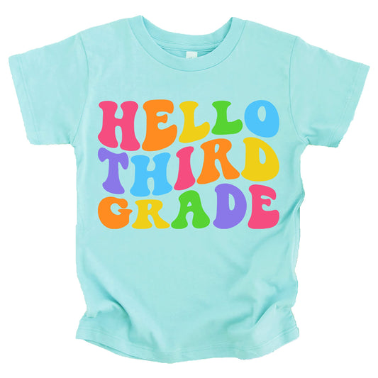 Front view of Hello 3rd Grade kids shirt in pink with colorful wavy lettering