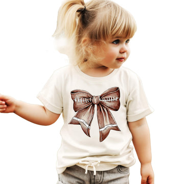 Close-up of football bow graphic on a natural kids tee showing vibrant print quality
