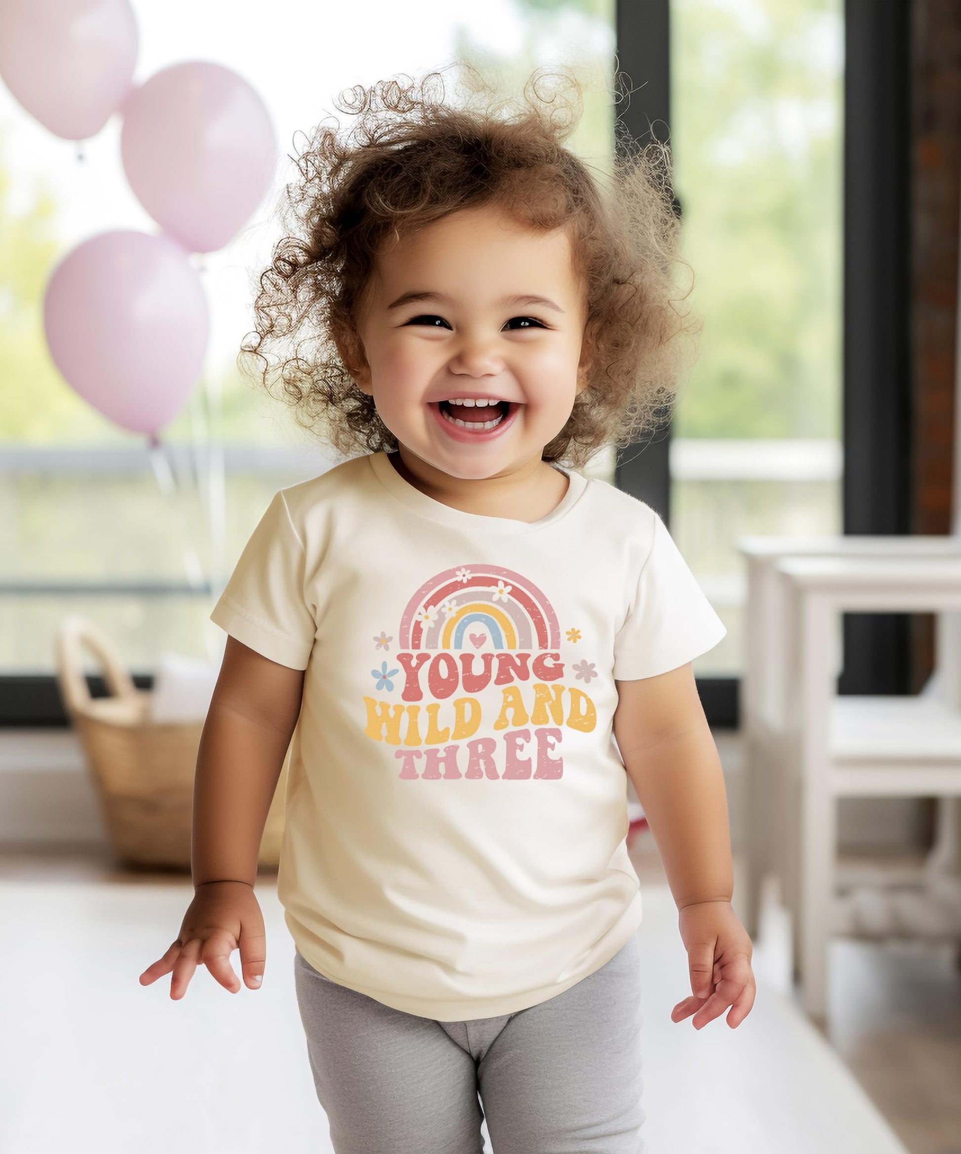Detail shot of retro rainbow lettering on Young Wild Three birthday tee