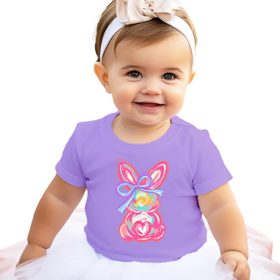 Flat lay of purple kids Easter graphic tee featuring painted bunny and bow design