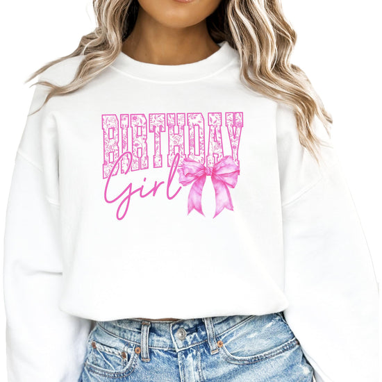 Toddler girl wearing white Birthday Girl bow sweatshirt with pink graphic lettering