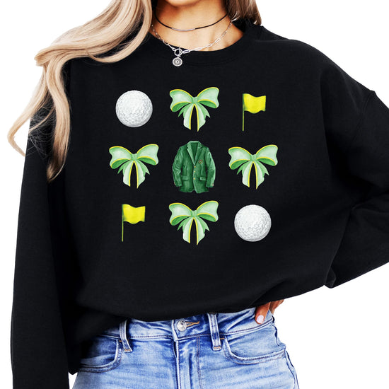 Close-up of green bows and golf balls graphic on white women's pullover sweatshirt