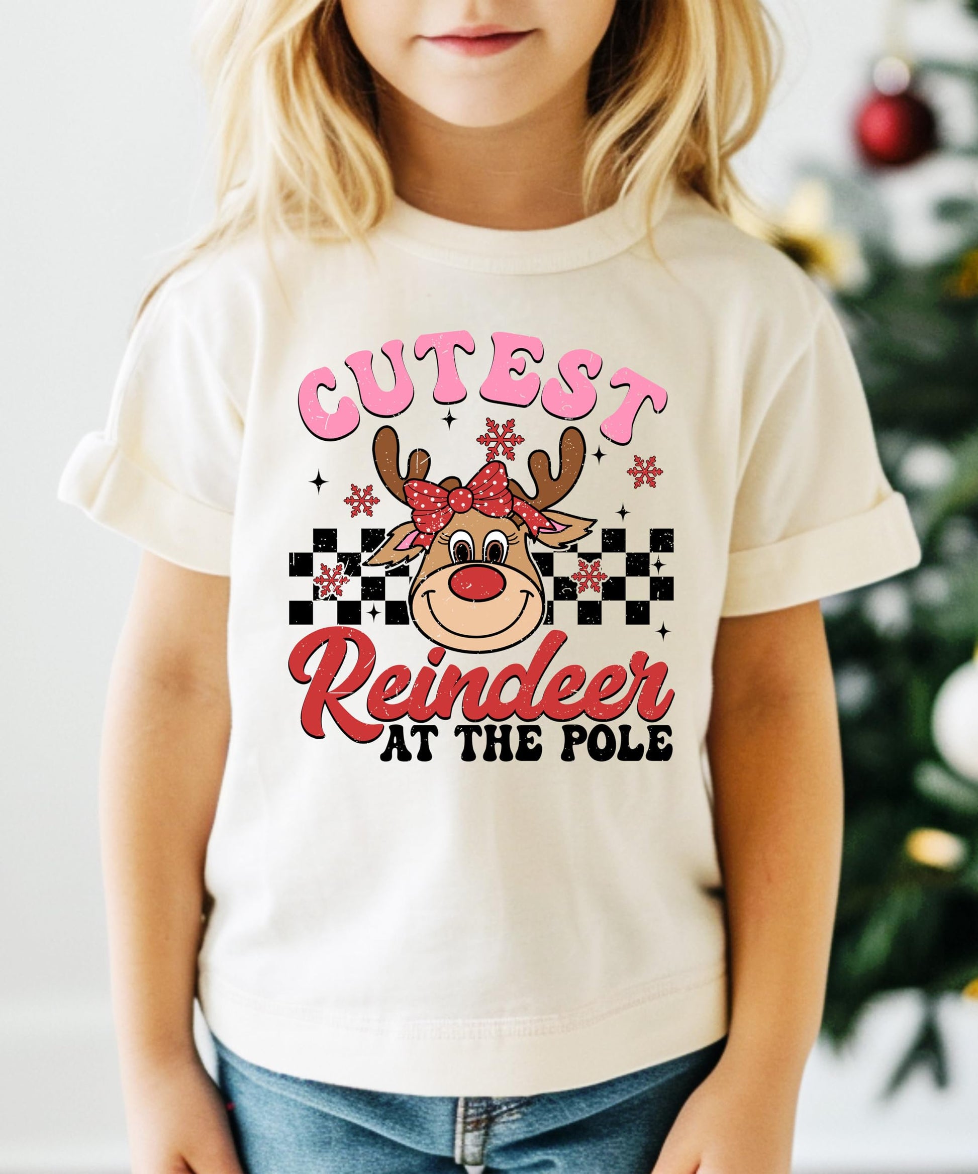 Close-up of cute reindeer graphic with festive details on girls' holiday t-shirt