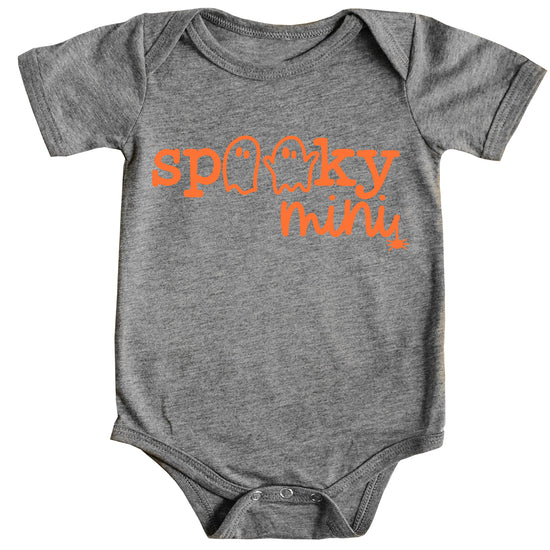 Side view of baby Halloween bodysuit with spooky orange ghost print on vintage burgundy fabric