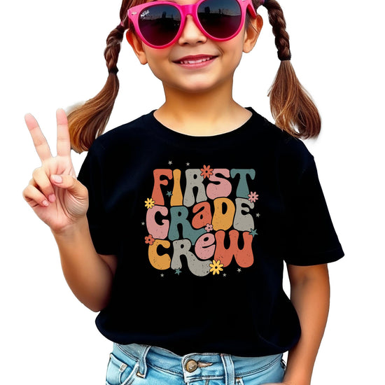Girls' colorful retro First Grade Crew graphic t-shirt by Olive Loves Apple, front view