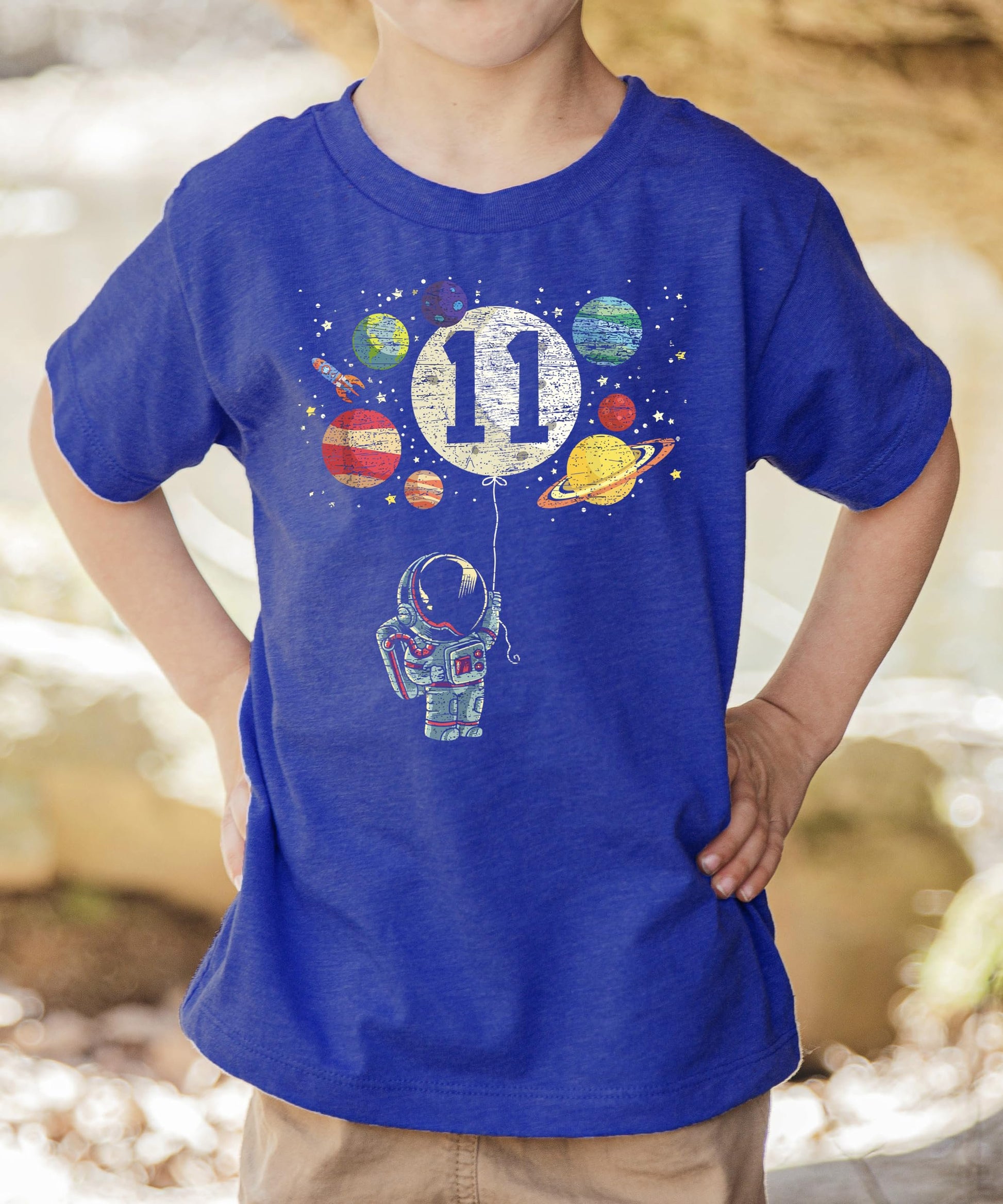 Close-up of astronaut and moon balloon graphic on kids 11th birthday shirt