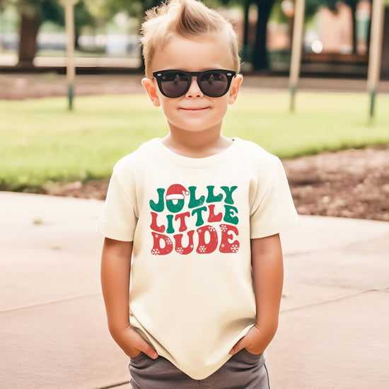 Close-up of green and red snowflake holiday graphic print on kids black tee