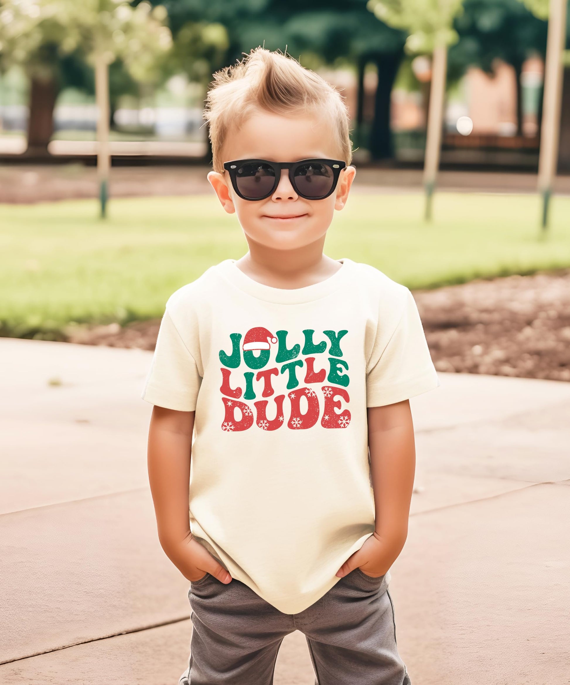Close-up of green and red snowflake holiday graphic print on kids black tee