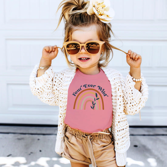 Side view of Four Ever Wild rainbow graphic birthday tee for toddler and youth girls