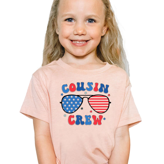 Close-up of patriotic sunglasses graphic with stars and stripes pattern on youth t-shirt