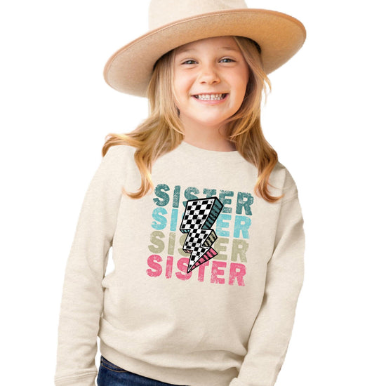 Side view of pink girls pullover sweatshirt with bold graphic print by Olive Loves Apple
