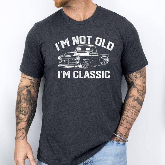 Lifestyle or detail shot of men's classic car dad joke graphic tee in black
