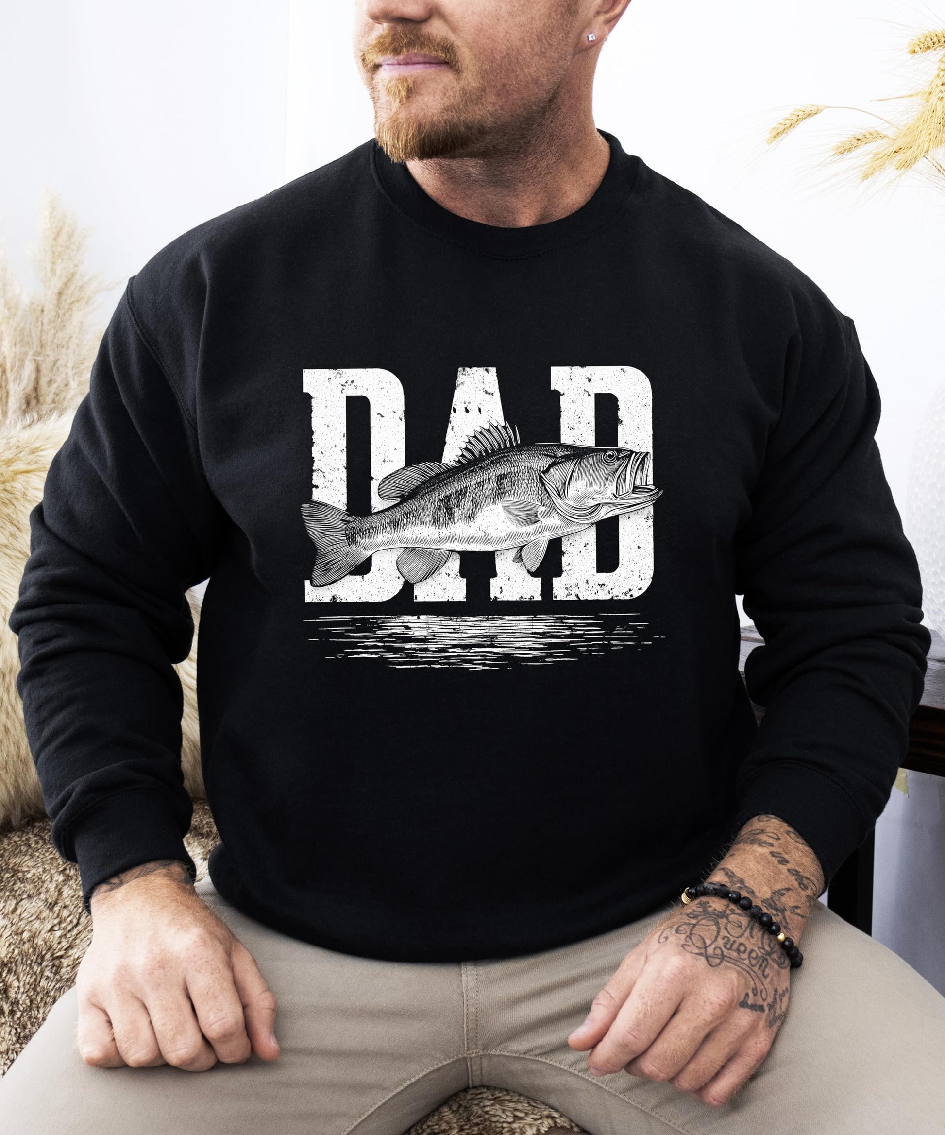 Detail shot of soft fabric and distressed fish graphic on white adult pullover sweatshirt