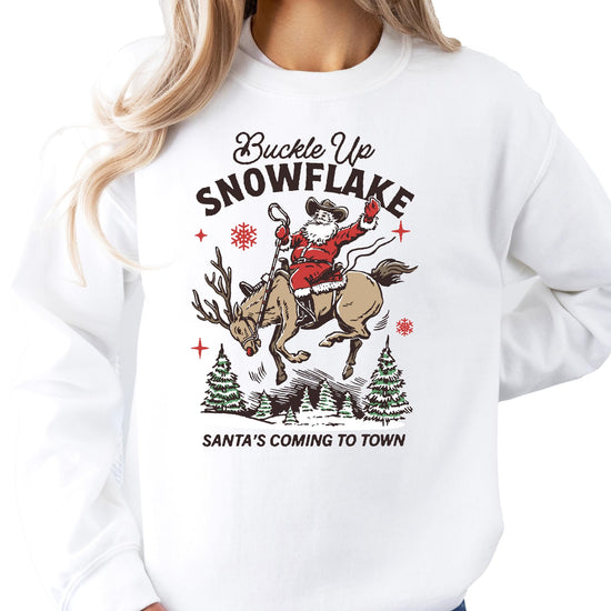 Close-up of Buckle Up Snowflake Cowboy Santa graphic print on gray unisex Christmas sweatshirt