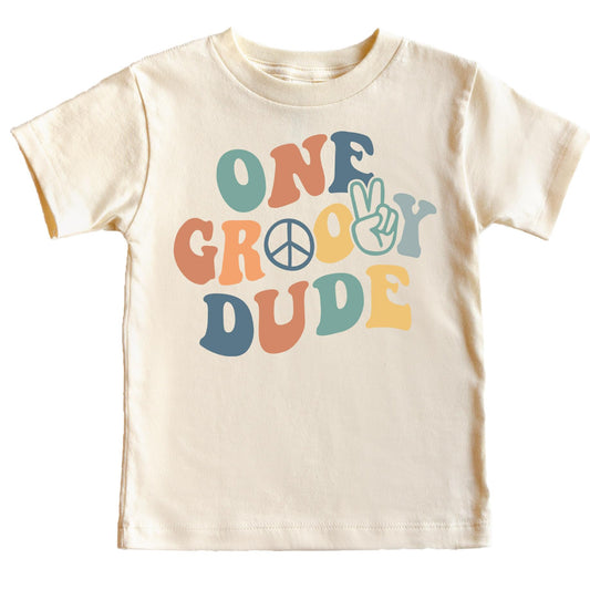 Close-up of groovy one birthday shirt design with peace sign and boho lettering for infant boys