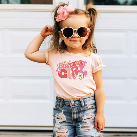 Youth girls birthday outfit featuring groovy daisy graphic tee in natural fabric