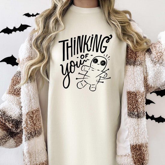 Side view of woman modeling witchy voodoo doll graphic tee shirt