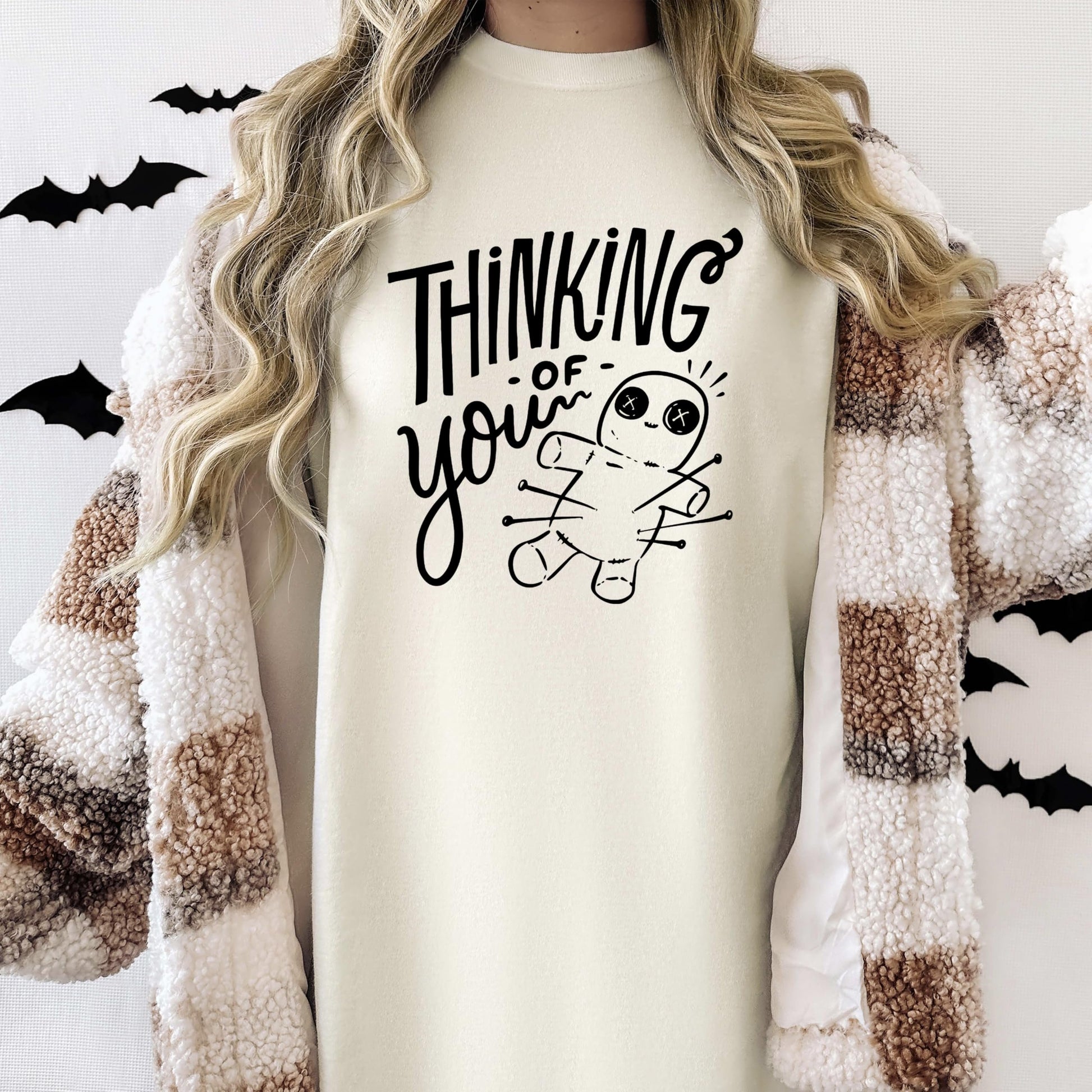 Side view of woman modeling witchy voodoo doll graphic tee shirt