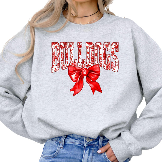 Flat lay of black Bulldogs spirit sweatshirt with red bow design