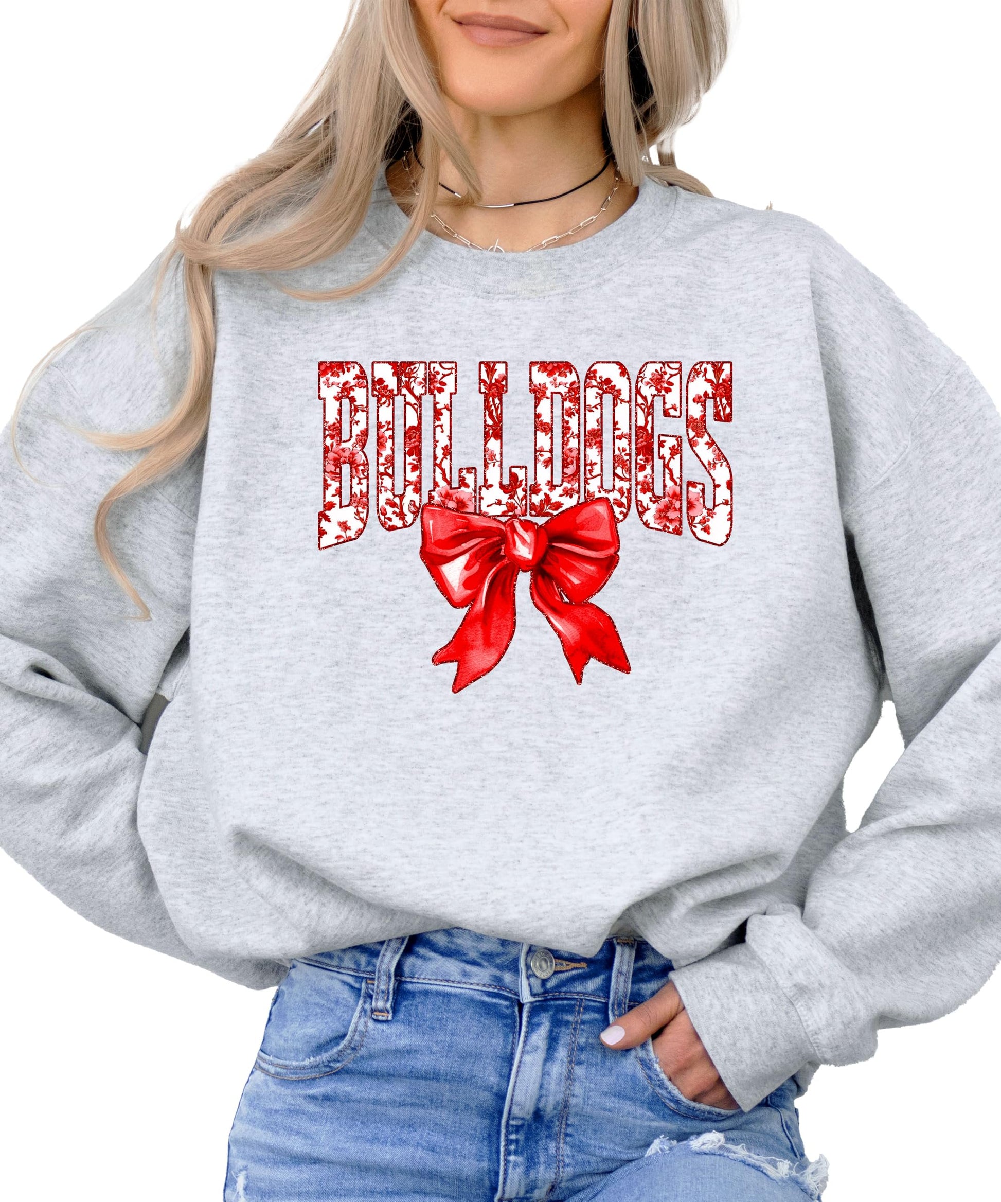 Flat lay of black Bulldogs spirit sweatshirt with red bow design