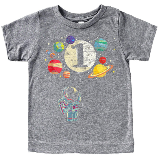 Close-up of space themed first birthday shirt design featuring rocket, moon balloon, and colorful planets