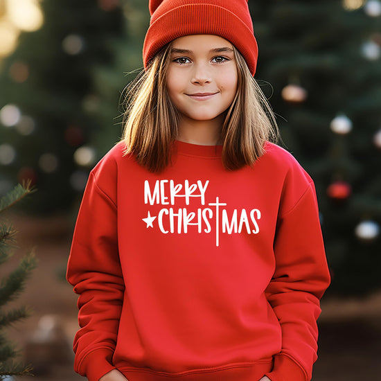 Styled lifestyle shot of red Merry Christmas cross pullover sweatshirt for holiday wear
