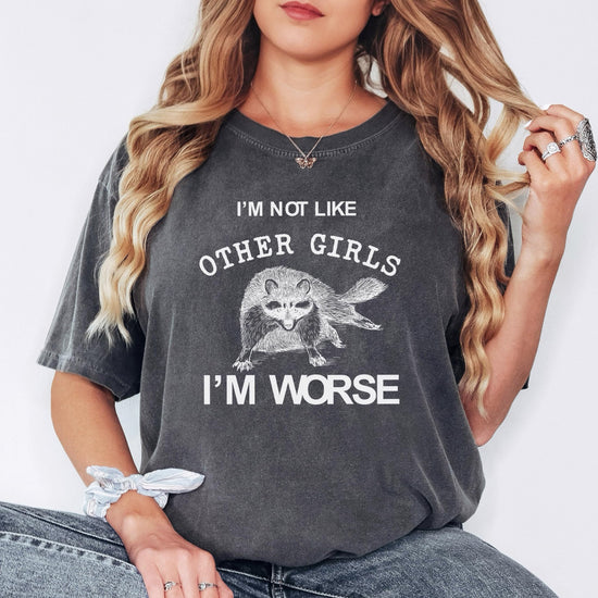 Flat lay of ivory funny raccoon graphic t-shirt with sarcastic women's slogan