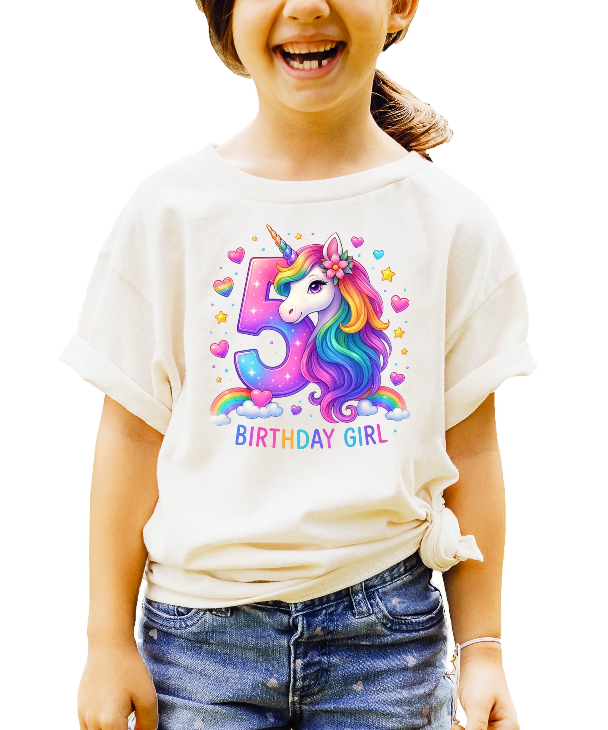 Flat lay of pink girls birthday shirt featuring colorful unicorn and number 5 design