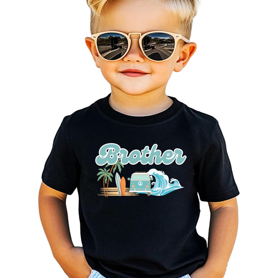 The Big One surf birthday daddy tee displayed on a hanger showing full graphic design detail