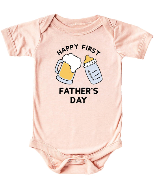 Close-up of Happy First Father's Day graphic print on peach baby bodysuit