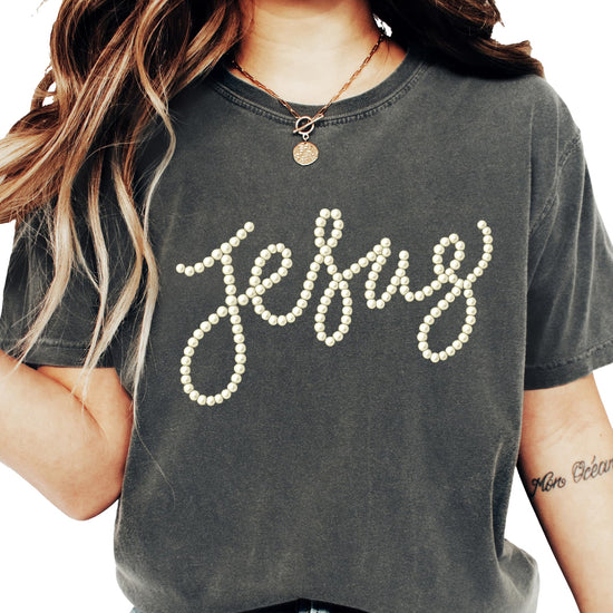 Close-up of pearl script Jesus design on a seafoam women's graphic tee