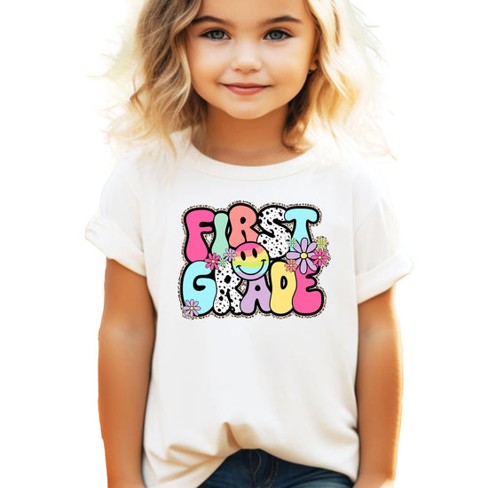 Close-up of first grade shirt design showing retro typography and vibrant colors