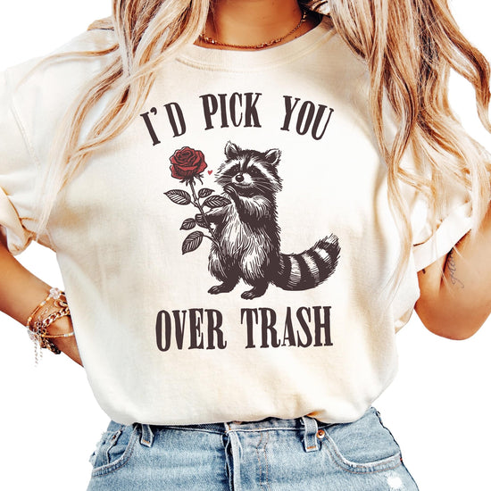 Flat lay of ivory women's graphic tee featuring humorous raccoon Valentine's Day design