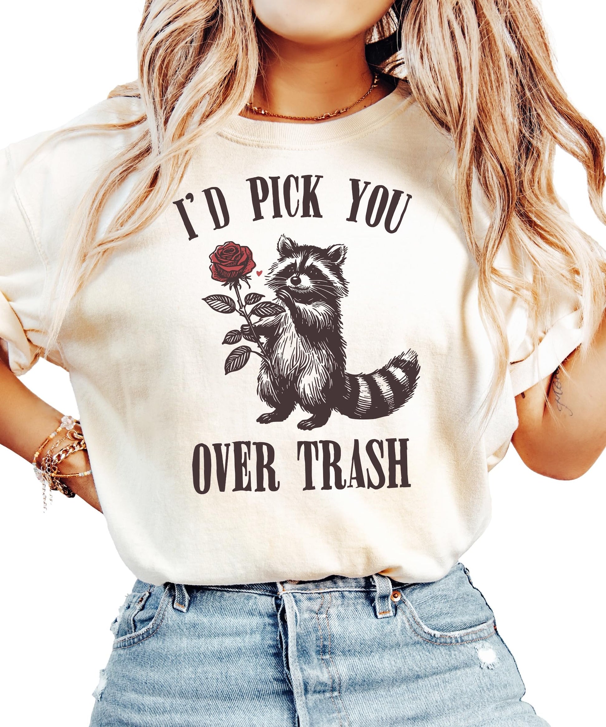 Flat lay of ivory women's graphic tee featuring humorous raccoon Valentine's Day design