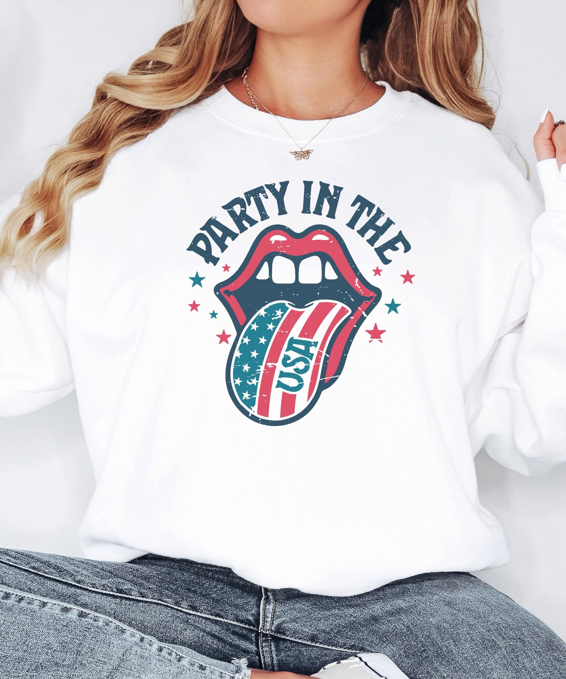 Women's white crewneck sweatshirt featuring retro America Party In The USA graphic, flat lay product view