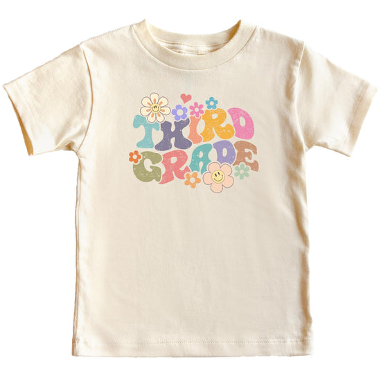 Young girl wearing 3rd grade groovy daisy first day of school t-shirt