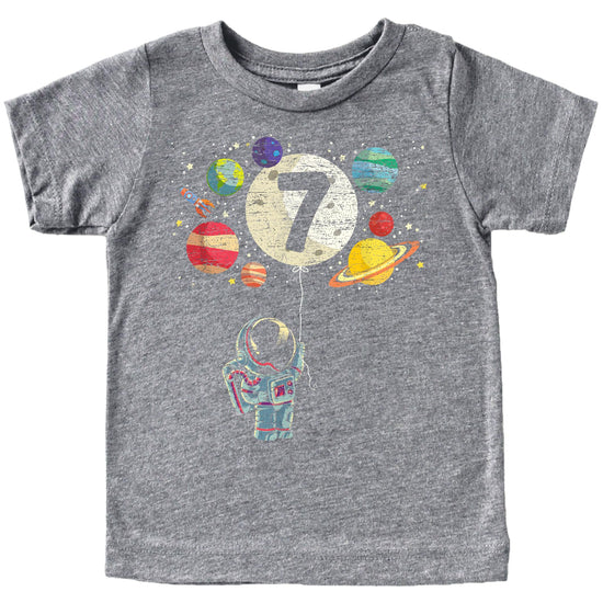 Front view of space-themed 7th birthday tee for boys and girls with rocket and planet design
